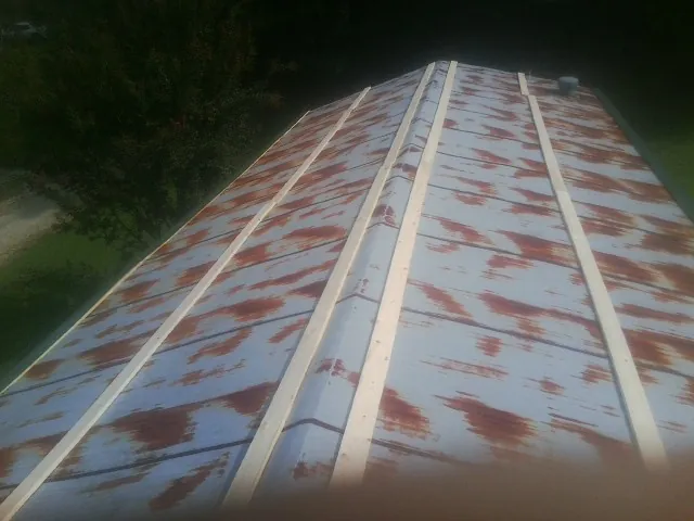Rusted metal roof panels with new wood purlins before replacement — Storm Damage Roof Repair in Middle Haddam by Roofing Brothers