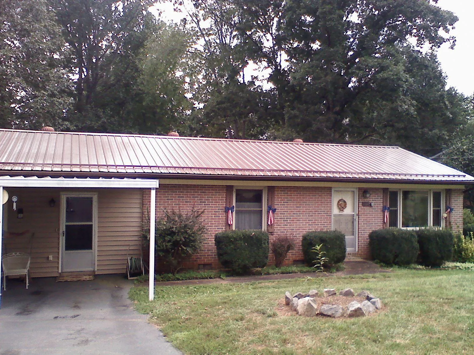 Bronze metal roof and carport on a brick ranch home — Roof Repair work by our crew in Middle Haddam