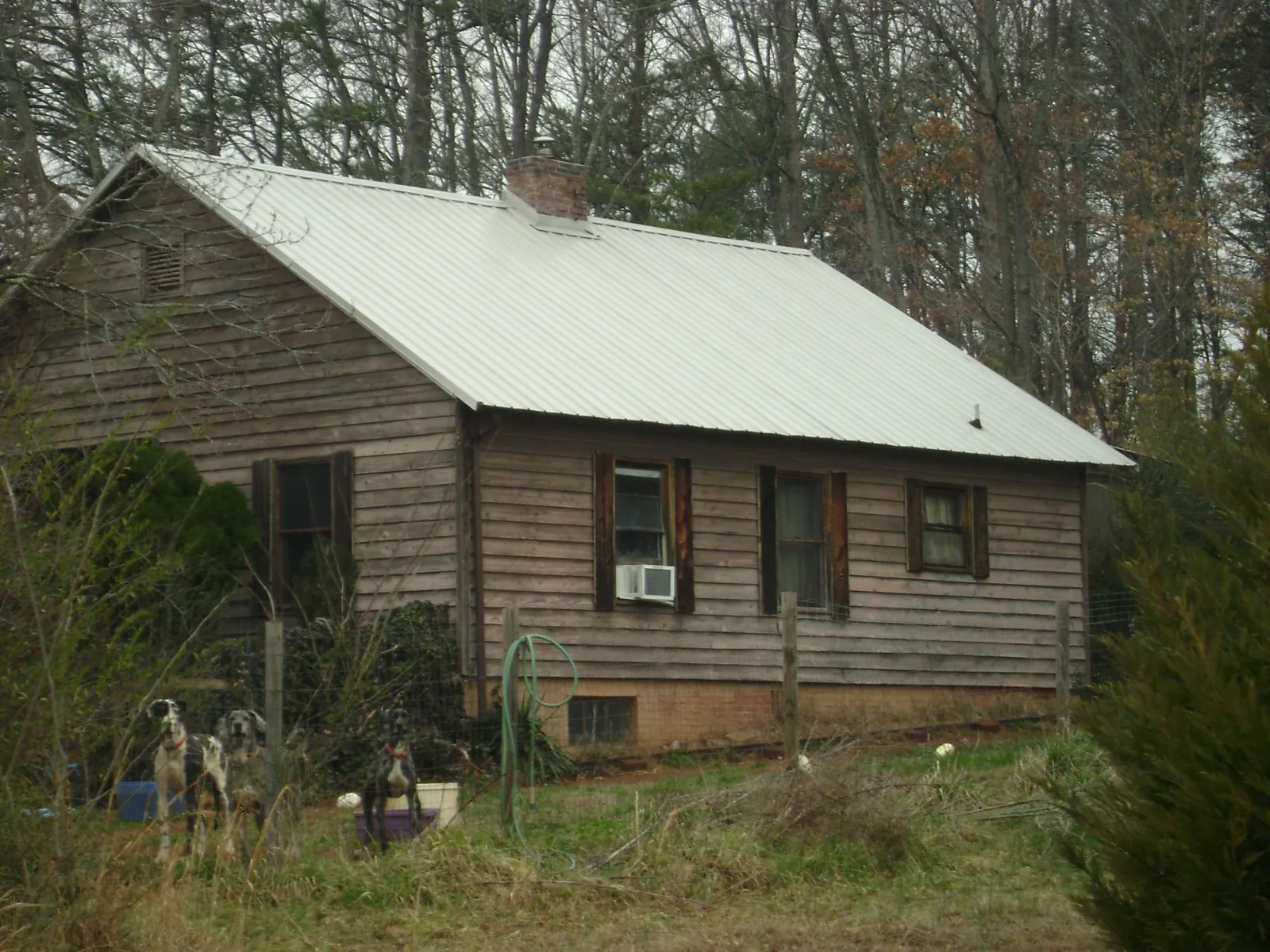 White metal roof on an old wood sided farmhouse, from a Metal Roof Installation job in Middle Haddam